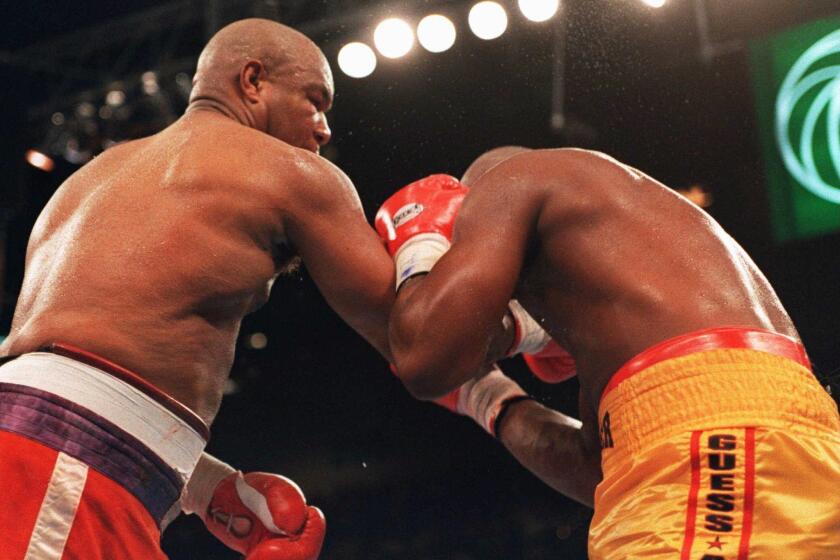 George Foreman follows through on the punch that knocked out Michael Moorer on Nov. 5, 1994.