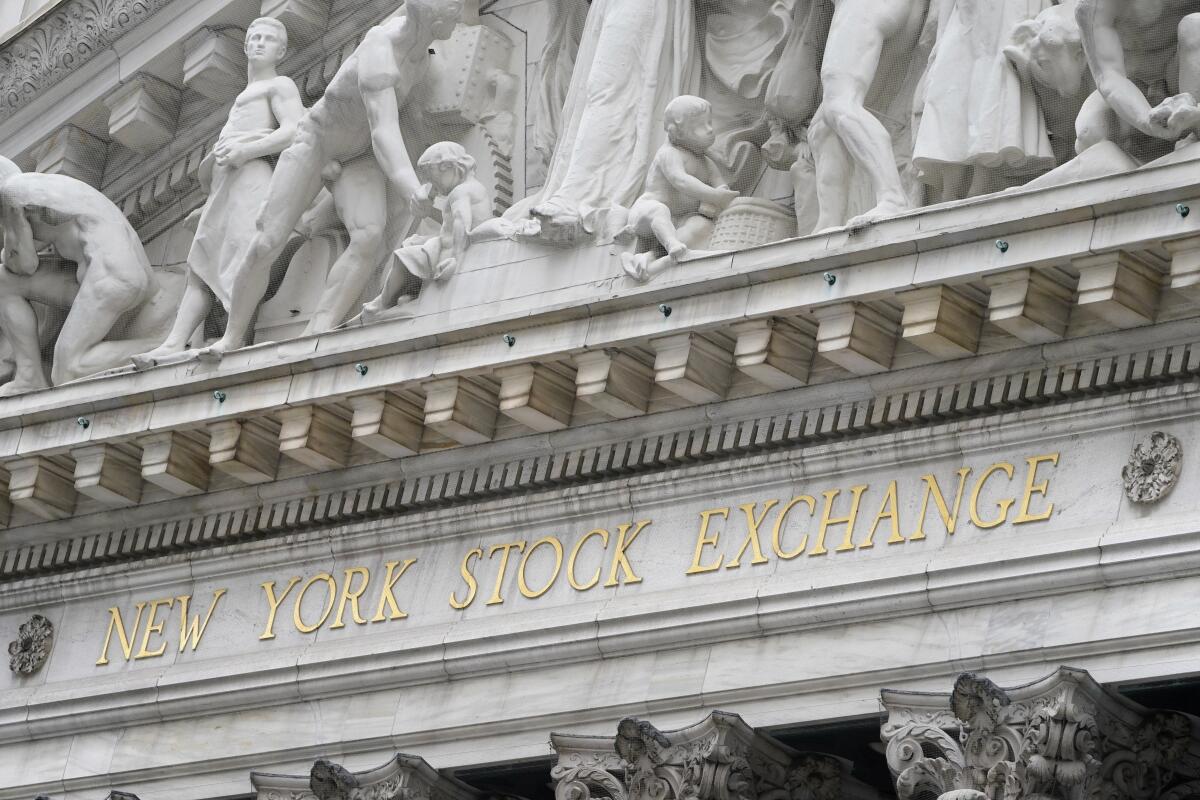 FILE - In this Nov. 23, 2020 file photo, stone sculptures adorn the New York Stock Exchange. Stocks are off to a strong start on Wall Street Monday, April 5, 2021, putting the S&P 500 on track to beat the record high it set last week. (AP Photo/Seth Wenig, File)