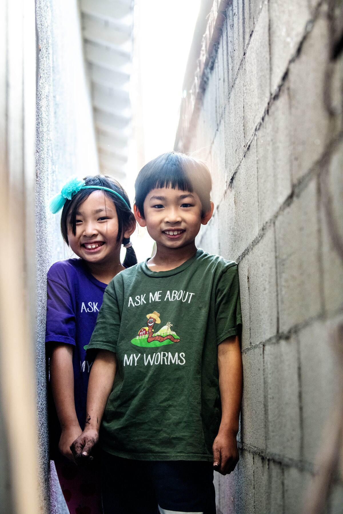 Young worm farmers wear T-shirts that say, "Ask me about my worms."