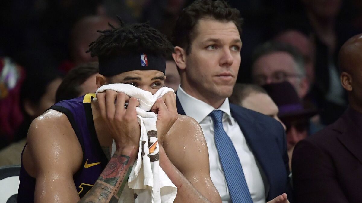 Lakers center JaVale McGee and coach Luke Walton watch the final seconds of a 119-112 loss to the Knicks on Jan. 4.
