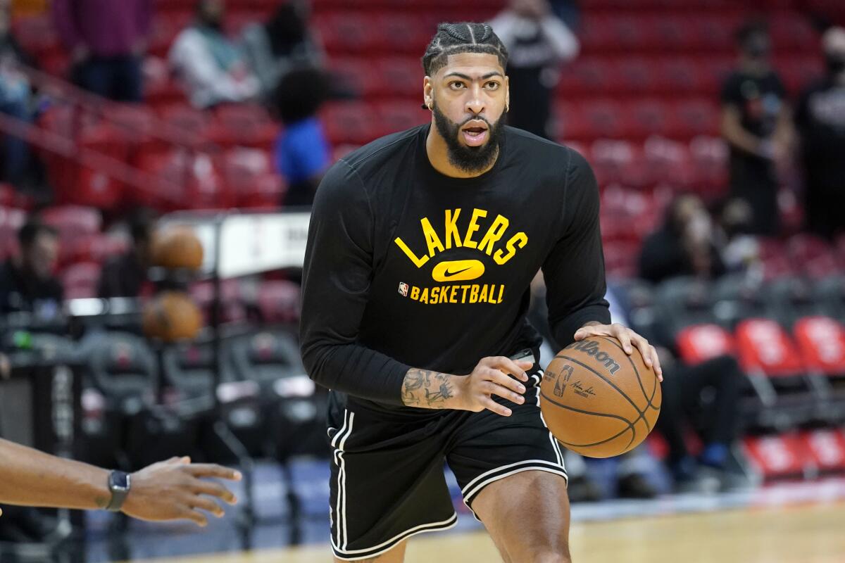 Lakers forward Anthony Davis practices on the court before a game earlier this season.