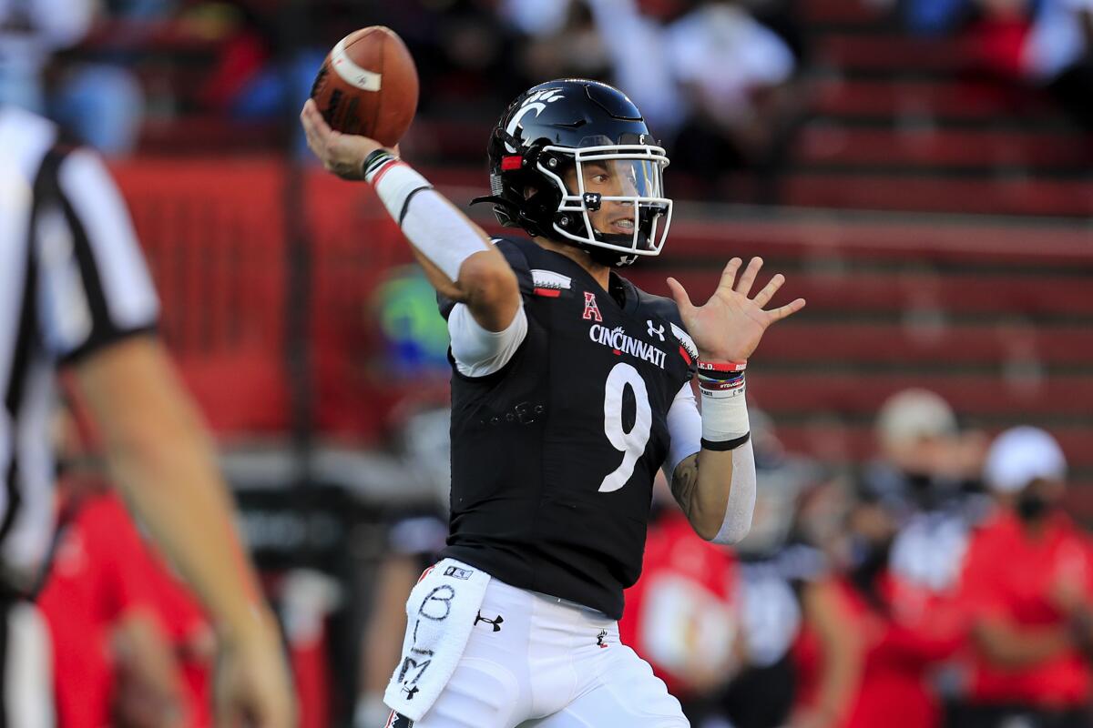 FILE - Cincinnati quarterback Desmond Ridder throws a pass during the first half of an NCAA college football game against Houston in Cincinnati, in this Saturday, Nov. 7, 2020, file photo. Ridder returns for his senior season, looking to add to his 6,905 career passing yards and 57 career touchdowns, but also to take on more of a leadership role. (AP Photo/Aaron Doster, File)
