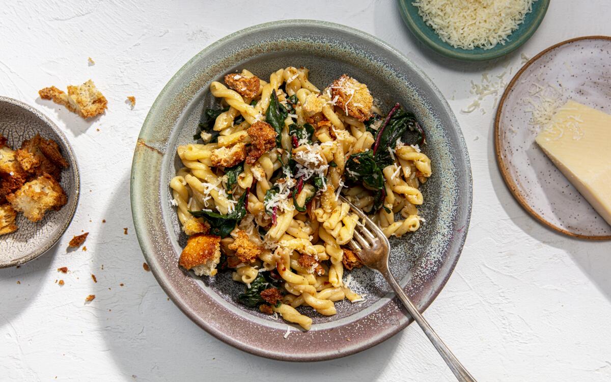 A pasta dish includes homemade bread crumbs and garlic-infused greens.