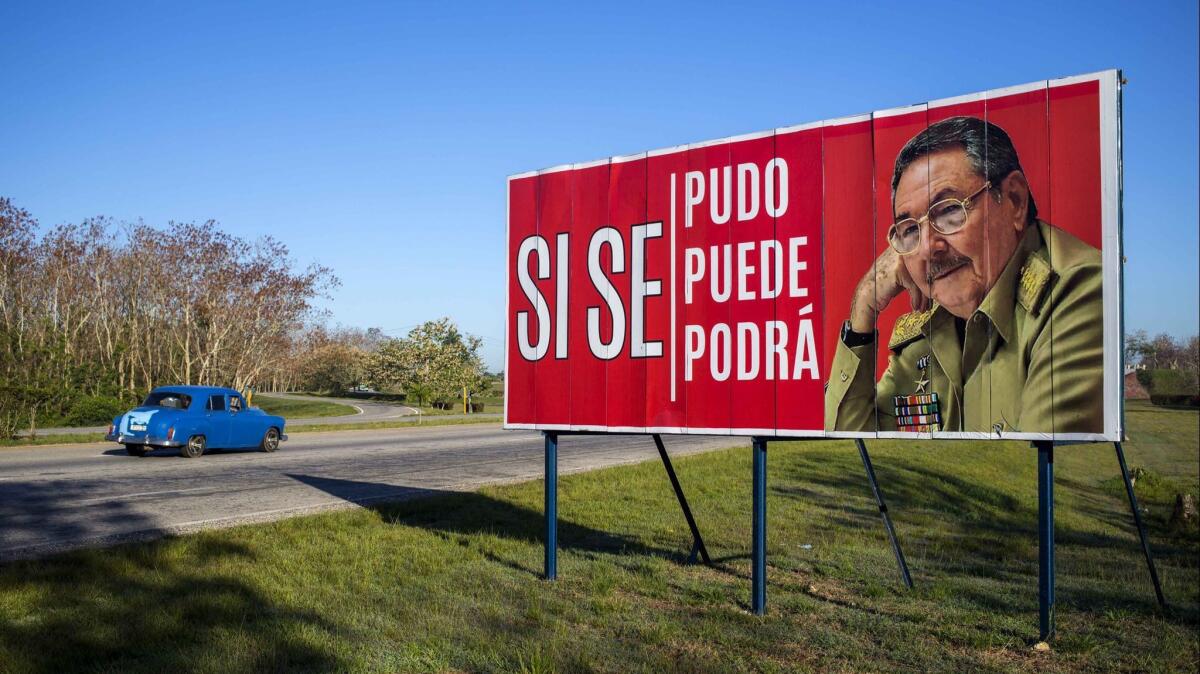 A car drives by a billboard outside Havana, Cuba that reads in Spanish "It was, is and will be done," with a picture of Cuba's President Raul Castro.
