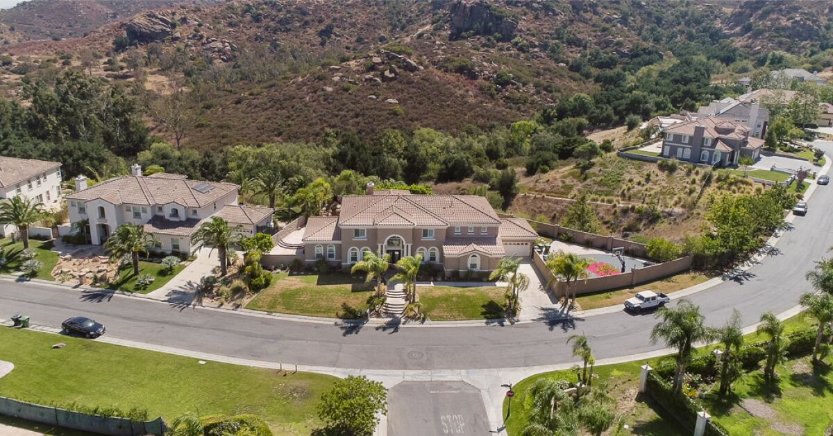 Built in 2005, the two-story home sits on a scenic acre with a swimming pool, spa and basketball court.