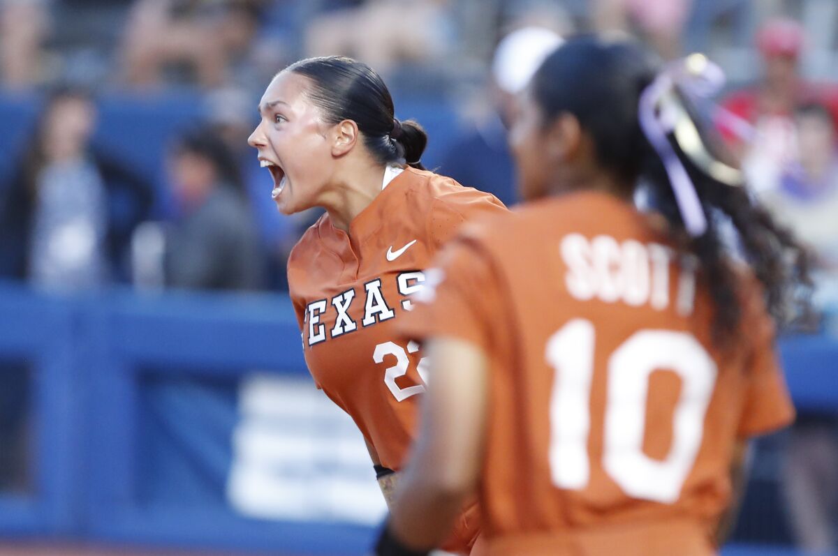 Texas' Estelle Czech (22) celebrates after her team defeated Arizona in an NCAA softball Women's College World Series game on Sunday, June 5, 2022, in Oklahoma City. (AP Photo/Alonzo Adams)