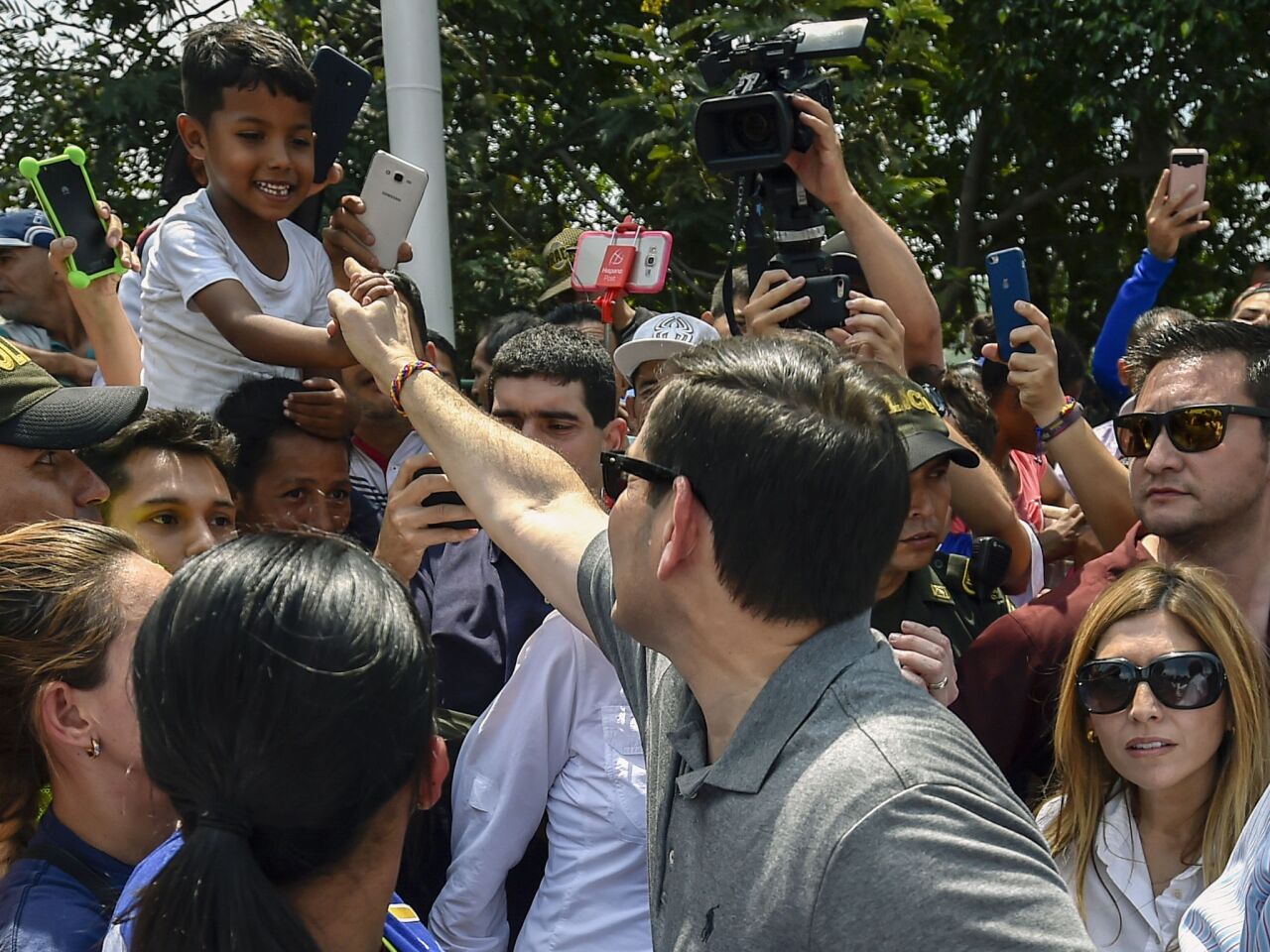 Sen. Marco Rubio greets a boy as he walks at the Simon Bolivar International Bridge in Cucuta, Colombia.