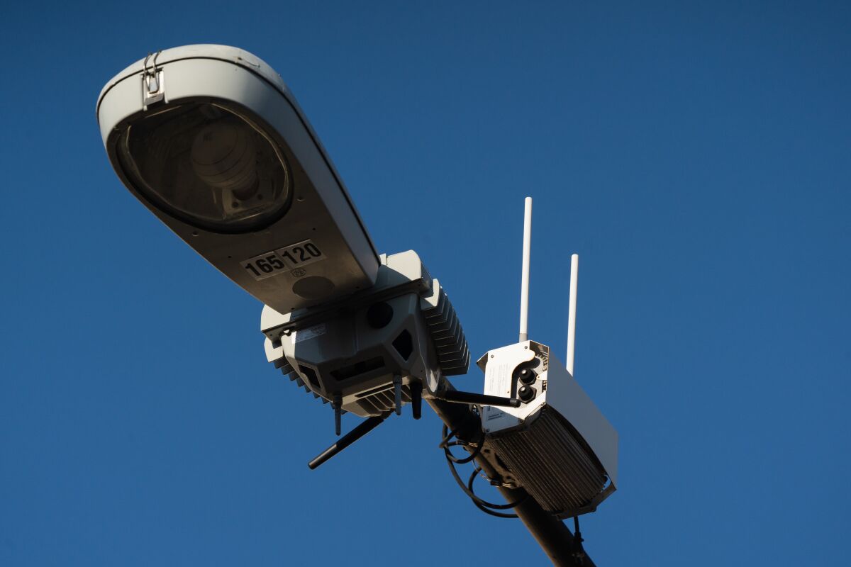 A camera mounted on a streetlight.