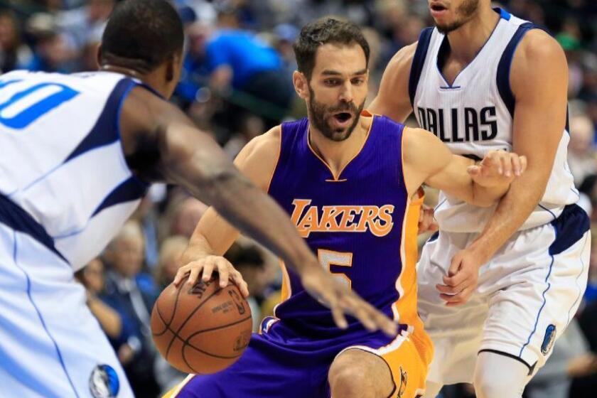 Lakers guard Jose Calderon looks to pass while being defended by Dallas forward Harrison Barnes and guard Seth Curry during a game on Jan. 22.