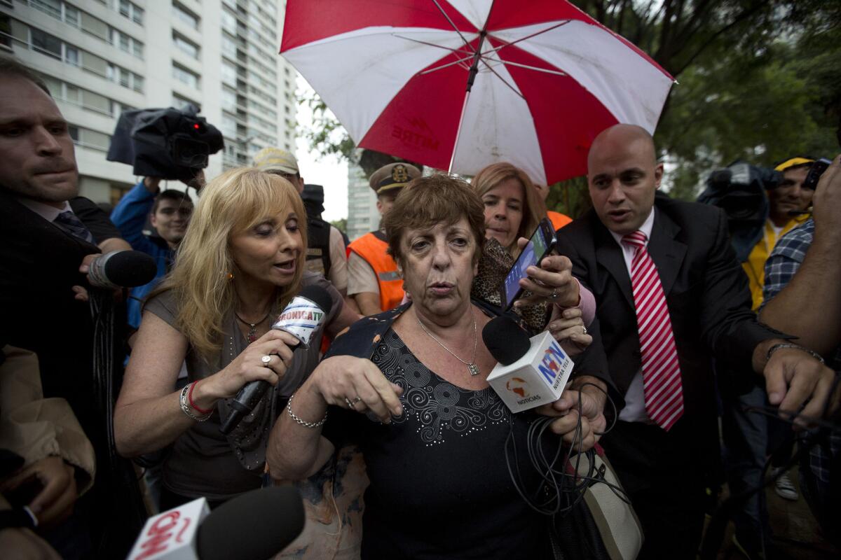 Prosecutor Viviana Fein on Monday talks to reporters outside the apartment where special prosecutor Alberto Nisman was found dead in Buenos Aires.