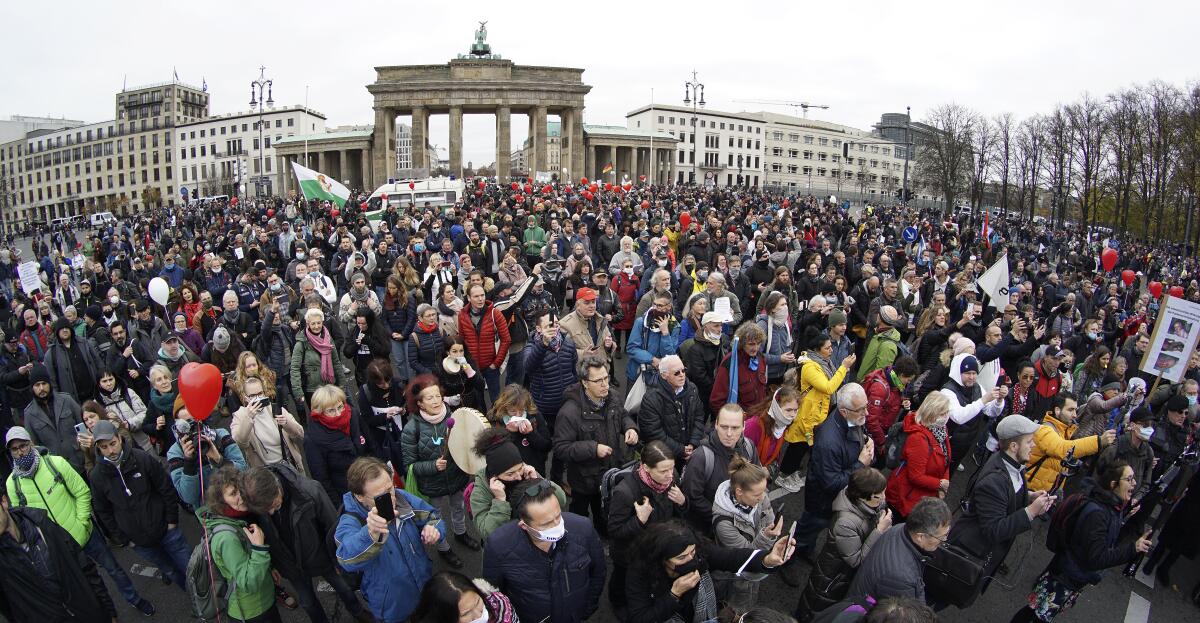 Protesters against coronavirus restrictions gather in front of the Brandenburg Gate in Berlin.