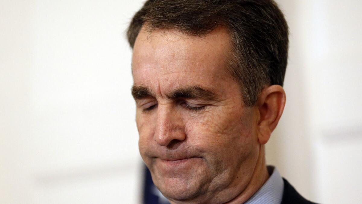 Virginia Gov. Ralph Northam pauses Saturday during a news conference in Richmond, Va. He is under fire for a photo that appeared in his college yearbook.