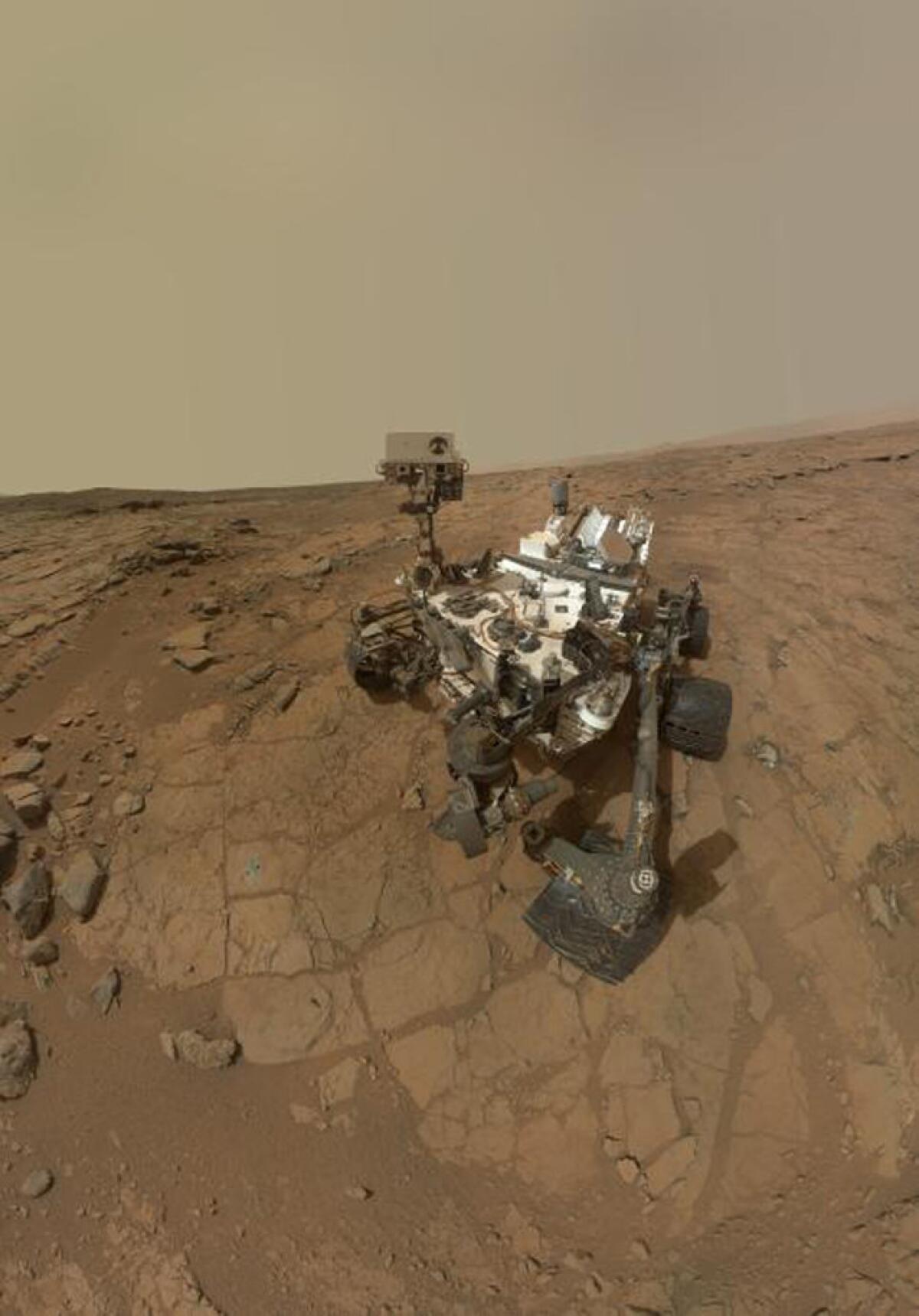 This self-portrait of NASA's Mars rover Curiosity obtained May 22, 2013 combines dozens of exposures taken by the rover's Mars Hand Lens Imager (MAHLI) during the 177th Martian day, or sol, of Curiosity's work on Mars (February 3, 2013), plus three exposures taken during Sol 270 (May 10, 2013) to update the appearance of part of the ground beside the rover. The updated area, which is in the lower left quadrant of the image, shows gray-powder and two holes where Curiosity used its drill on the rock target "John Klein." The portion has been spliced into a self-portrait that was prepared and released in February (PIA16764), before the use of the drill. The result shows what the site where the self-portrait was taken looked like by the time the rover was ready to drive away from that site in May 2013. The rover's robotic arm is not visible in the mosaic. MAHLI, which took the component images for this mosaic, is mounted on a turret at the end of the arm. Wrist motions and turret rotations on the arm allowed MAHLI to acquire the mosaic's component images. The arm was positioned out of the shot in the images, or portions of images, used in the mosaic.