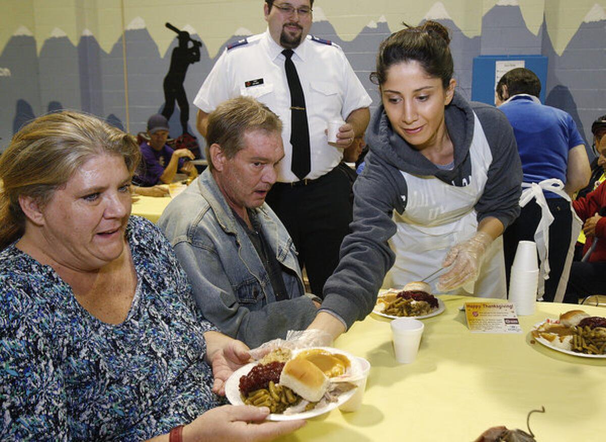 First time volunteer Gayaneh Gharakhani serves a meal at the annual Thanksgiving Day at the Salvation Army in Glendale on Thursday, November 28, 2013. A team of 60-70 volunteers helped to serve between 300-400 meals. (Tim Berger/Staff Photographer)