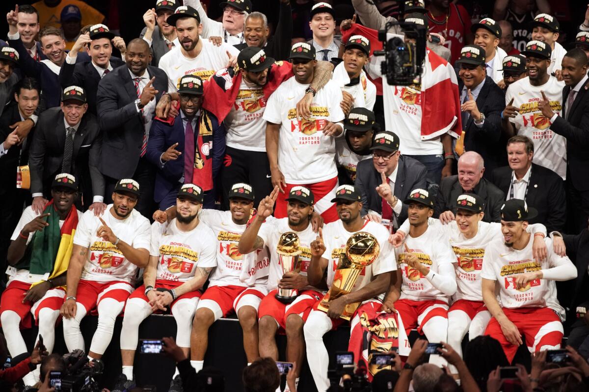 Toronto Raptors players and coaches sit for a team photo after the Raptors defeated the Golden State Warriors in Game 6 of the NBA Finals in Oakland.