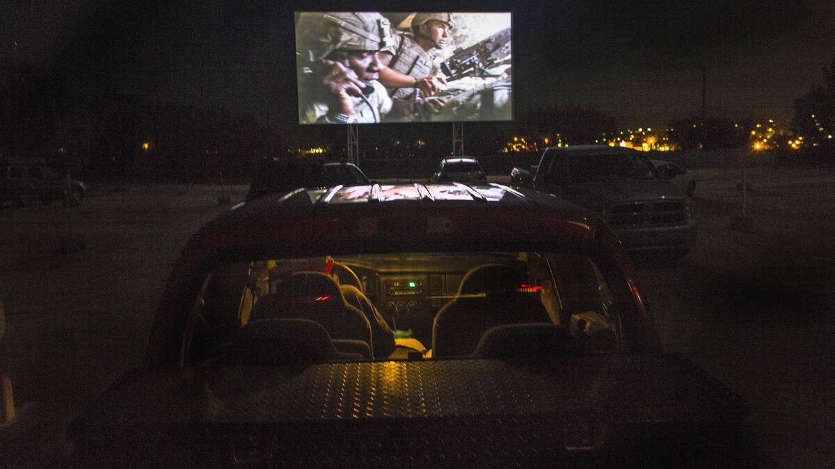 Army veteran John King of Twentynine Palms watches the Afghan war movie "Restrepo" from inside his pickup truck during the Military Film Festival at Smith's Ranch Drive-In in Twentynine Palms, Calif.