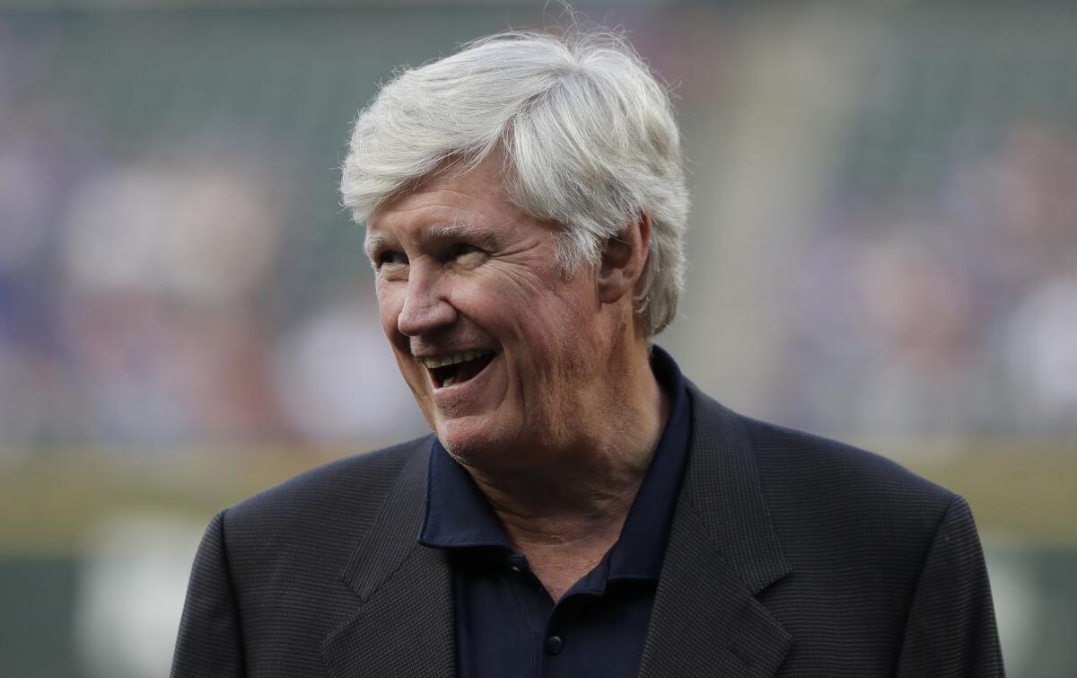 Seattle Mariners owner John Stanton stands on the field.