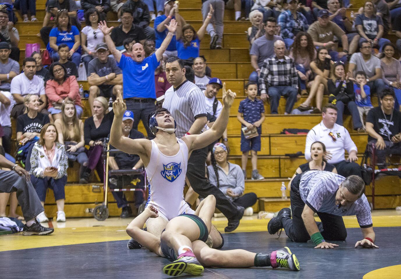 Fountain ValleyÕs Trenton Ching celebrates after pinning PacificaÕs Tim Brown in the 160 pound weight class during the CIF Southern Section Southern Division Wrestling Championships at Brea Olinda High School on Saturday, February 17.