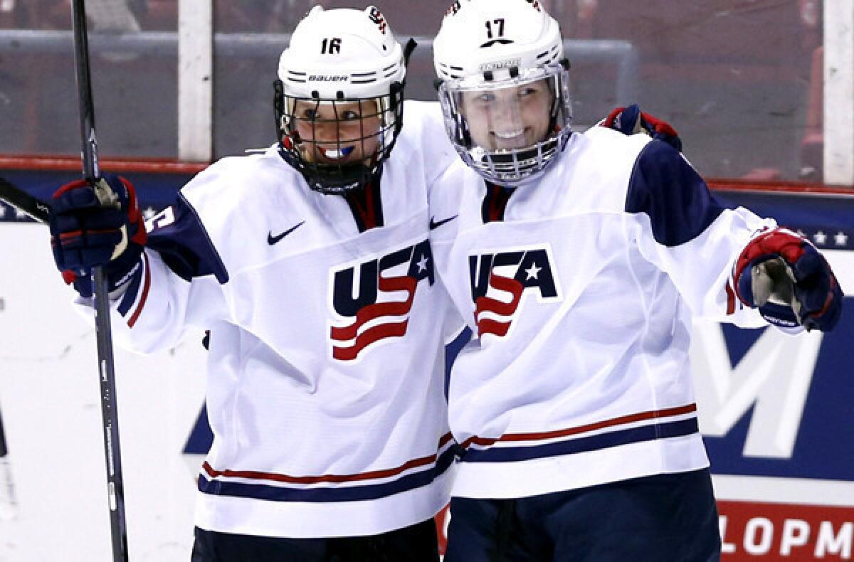 U.S. teammates Kelli Stack (16) and Jocelyne Lamoureux (17) celebrate a goal by Lamoureux during the second period of their game against Sweden on Saturday.