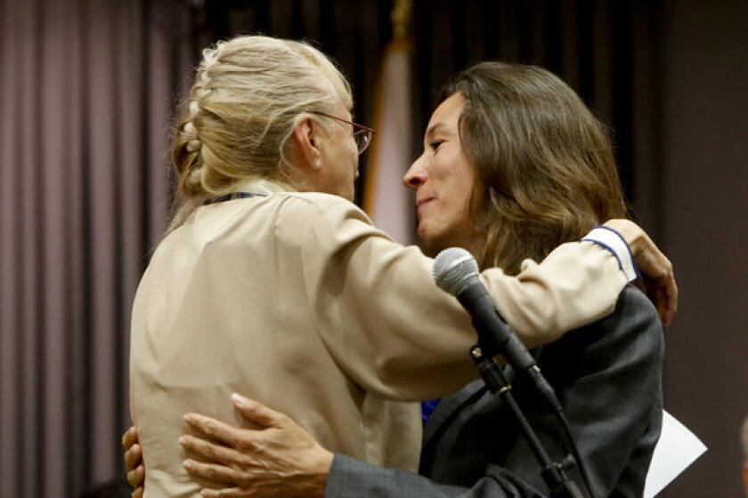 Newly elected L.A. school board member Monica Ratliff, right, hugs her mother, Yolanda Asenjo Padilla Ratliff, who administered the oath of office to her daughter -- first in Spanish, then in English.