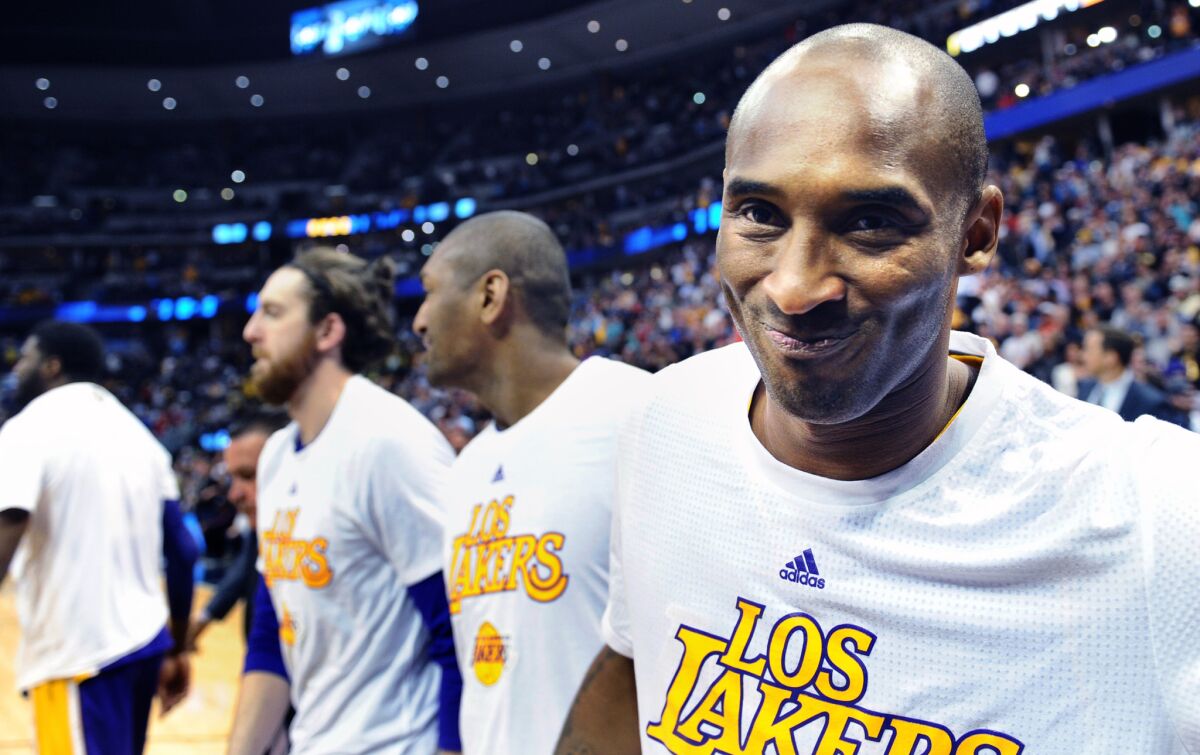 Kobe Bryant smiles as he leaves the court after his final game in Denver on March 2, 2016.