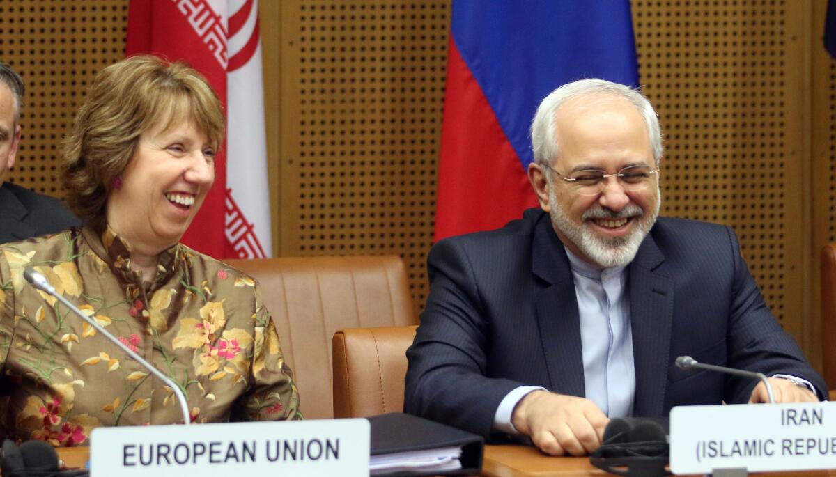 European Union foreign policy chief Catherine Ashton and Iranian Foreign Minister Mohammad Javad Zarif wait for the start of closed-door nuclear talks in Vienna.