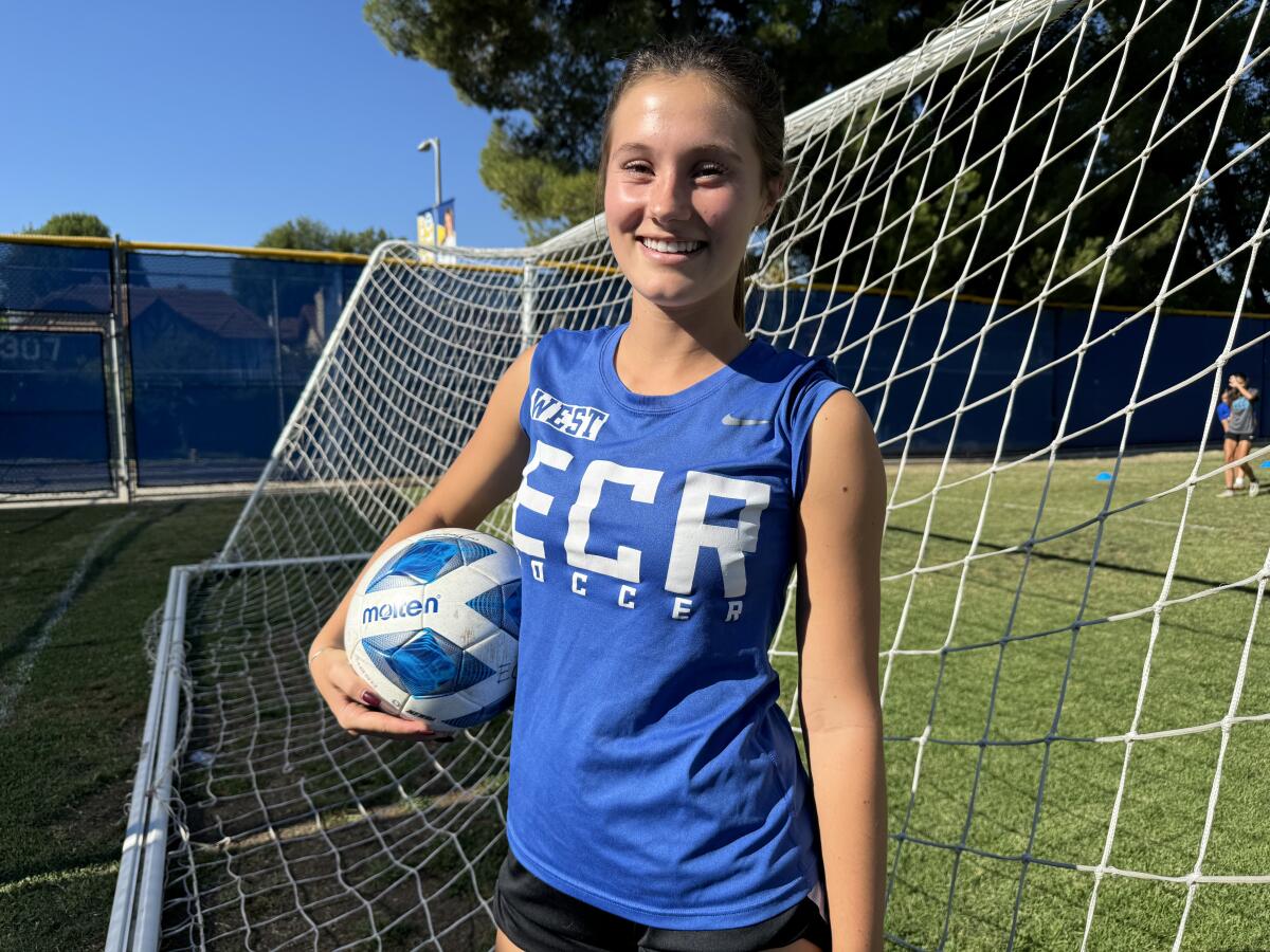 Ava Tibor poses for a photo with a soccer ball under her right arm at the El Camino Real High soccer field.