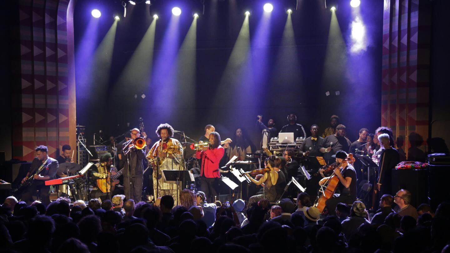 Saxophonist Kamasi Washington introduces his massive jazz collection called "The Epic" as colleagues pack the stage at the Regent in downtown Los Angeles.
