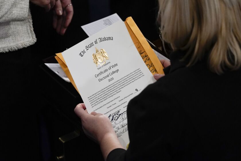 The certification of Electoral College votes for the state of Alabama is unsealed during a joint session of the House and Senate convenes to confirm the electoral votes cast in November's election, at the Capitol, Wednesday, Jan 6, 2021. (AP Photo/Andrew Harnik)