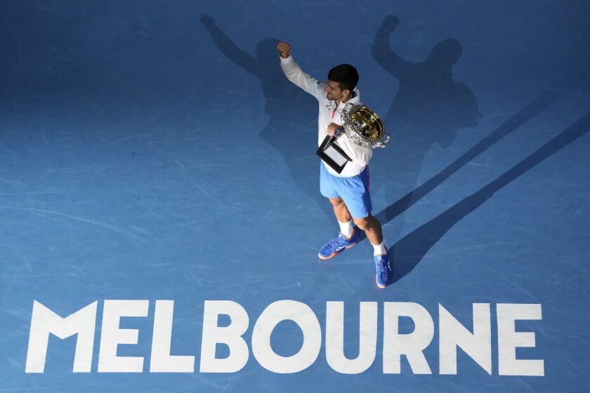 Novak Djokovic of Serbia reacts as he holds the Norman Brookes Challenge Cup after defeating Stefanos Tsitsipas of Greece in the men's singles final at the Australian Open tennis championship in Melbourne, Australia, Sunday, Jan. 29, 2023. (AP Photo/Ng Han Guan)
