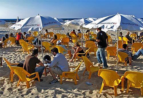 Beach goers soak up the sun in Tel Aviv along the Mediterranean Sea.