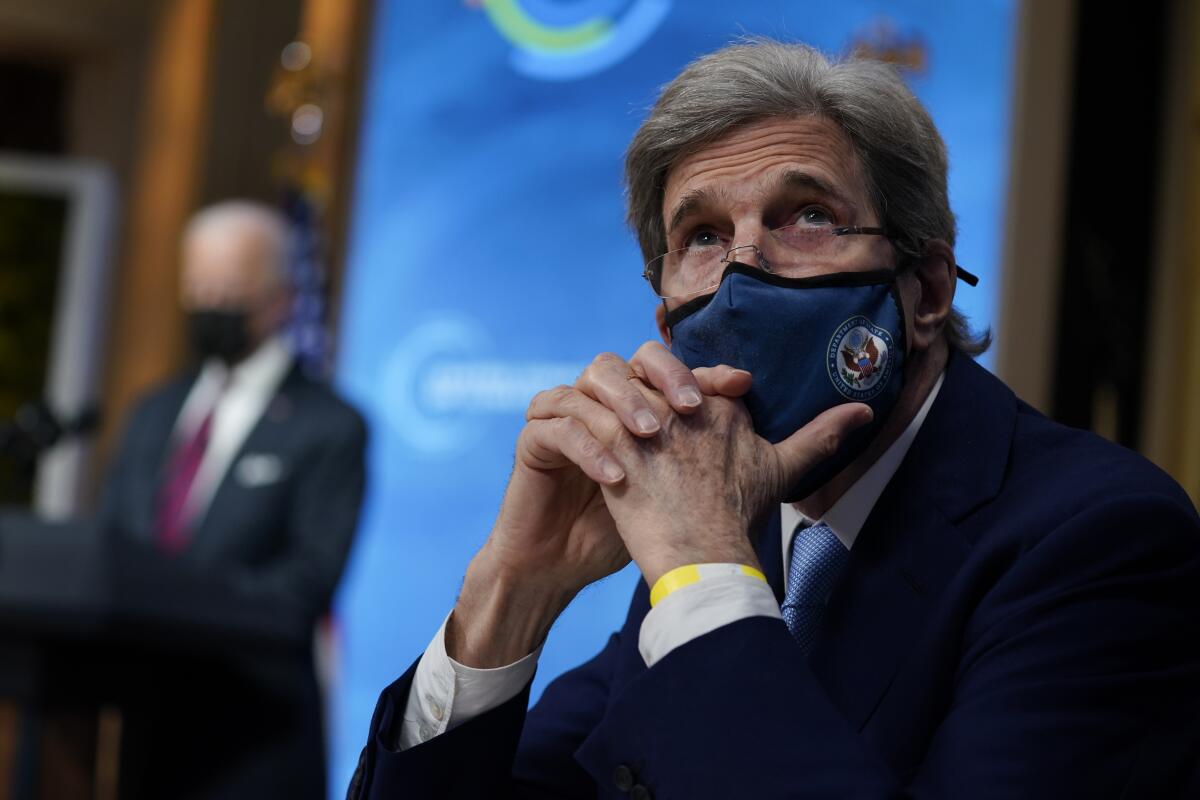 John Kerry looks on as President Biden speaks at a climate summit from the East Room of the White House on April 22, 2021.