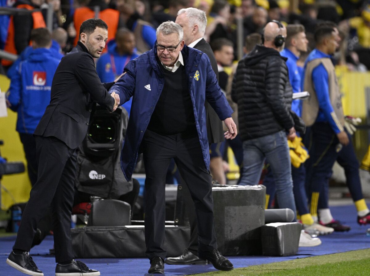 Belgium's coach Domenico Tedesco, left, and Sweden's coach Janne Andersson shake hands after the Euro 2024 group F qualifying soccer match between Sweden and Belgium at Friends Arena in Stockholm, Friday March 24, 2023. (Anders Wiklund/TT News Agency via AP)