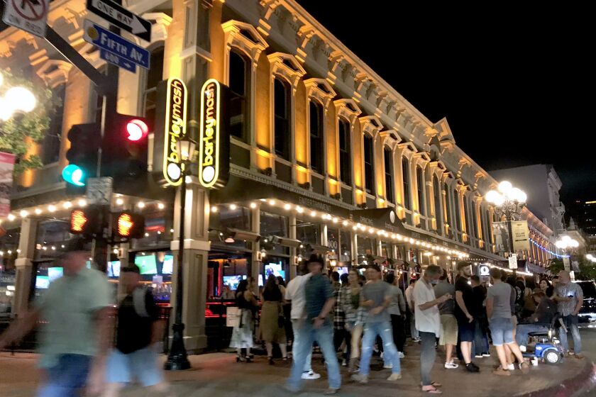 People enjoy a night out in the Gaslamp Quarter in San Diego on Saturday, June 13, 2020.