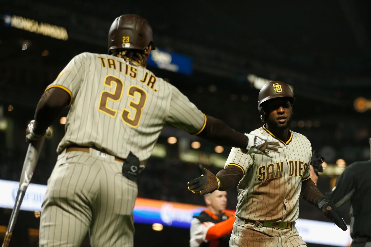 The Padres' Jurickson Profar celebrates with Fernando Tatis Jr. 