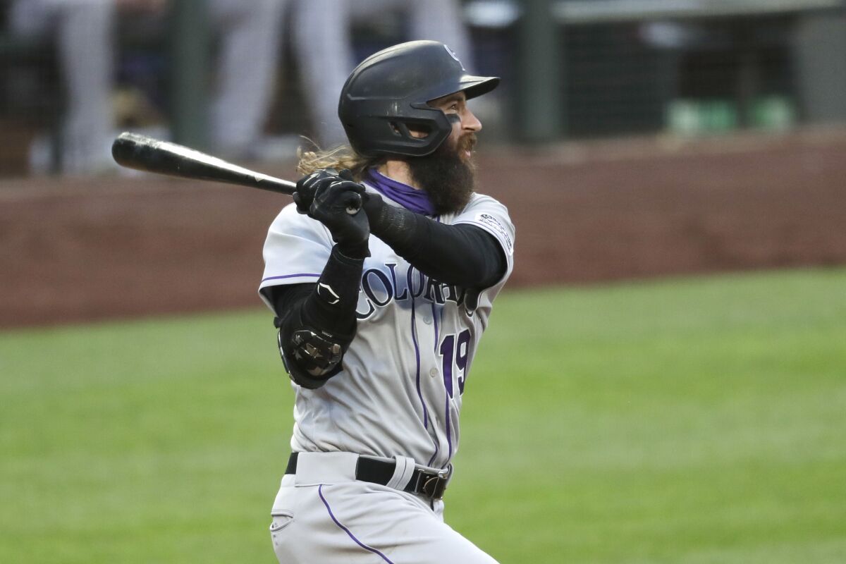 Colorado Rockies' Charlie Blackmon watches his three-run double against the Seattle Mariners during the fifth inning of a baseball game Saturday, Aug. 8, 2020, in Seattle. (AP Photo/Elaine Thompson)