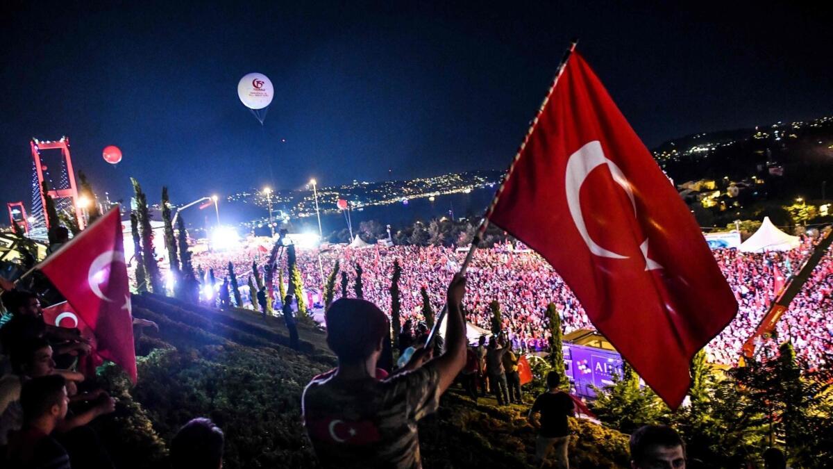 People gather at Martyrs Bridge in Istanbul, Turkey, on July 15, 2018, to mark the second anniversary of a failed coup attempt against President Recep Tayyip Erdogan.
