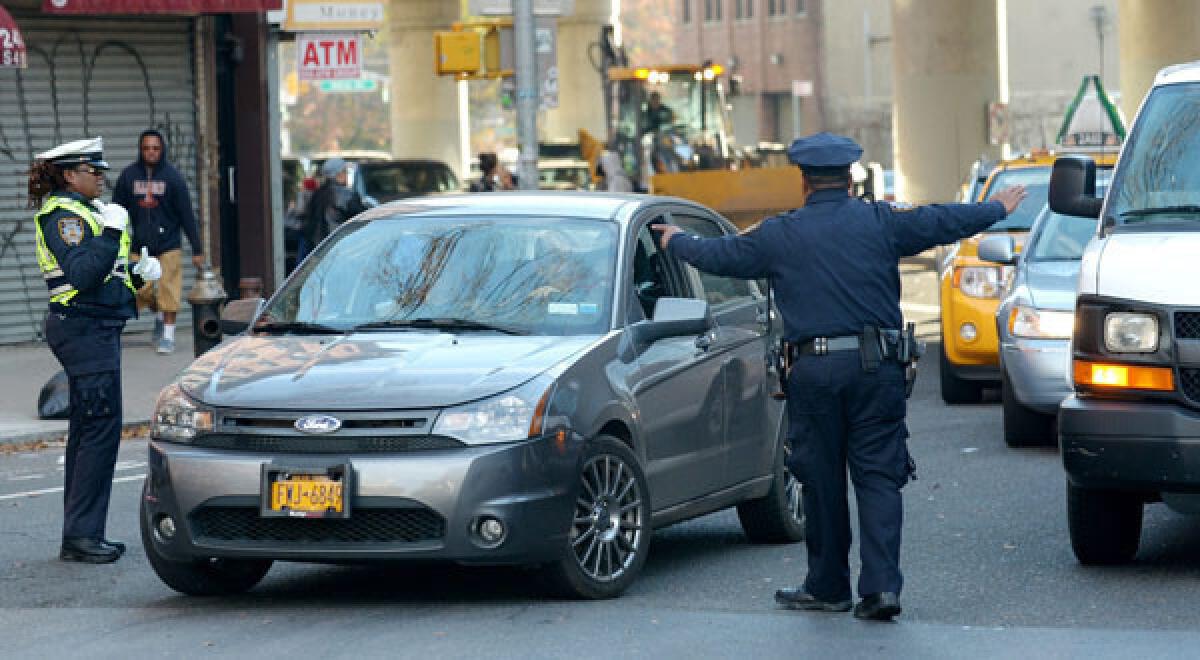 Police officers manage bridge traffic in Brooklyn after super storm Sandy.