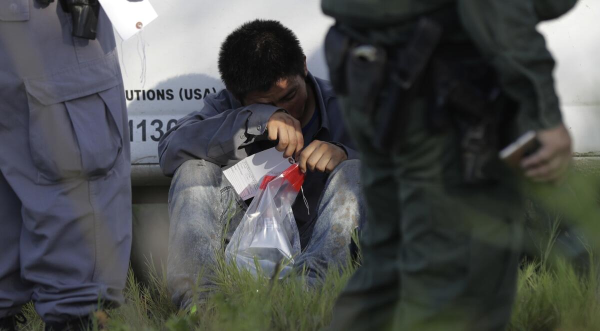 A suspected immigrant is detained at the border by U.S. authorities on Aug. 11, 2017