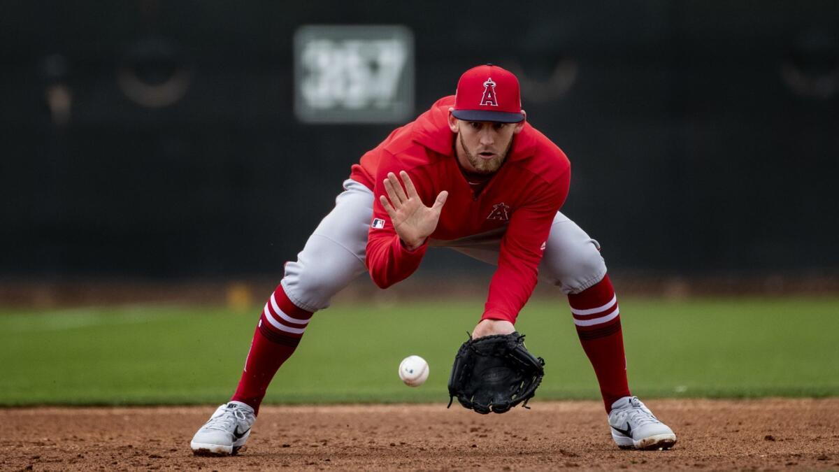 Angels third baseman Taylor Ward takes grounders during spring training at Tempe Diablo Stadium on Feb. 18.