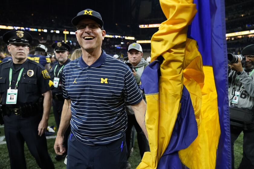 Michigan head coach Jim Harbaugh smiles after defeating Purdue in the Big Ten championship NCAA college football game, early Sunday, Dec. 4, 2022, in Indianapolis. Michigan won, 43-22. (AP Photo/Michael Conroy)