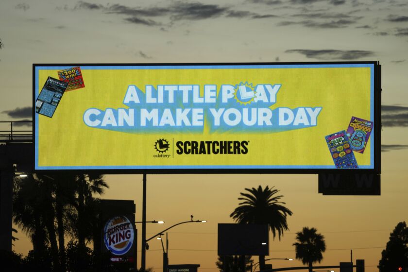 A billboard promoting the California Lottery Scratchers game with the words "A Little Play Can Make Your Day," Sunday, Sept. 11 2022, in Inglewood, Calif. (Kirby Lee via AP)