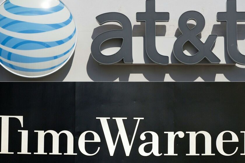 (FILES) This file combination of pictures created on October 21, 2016 shows an AT&T cellphone store (TOP) in Springfield, Virginia, on October 23, 2014, and the Time Warner company logo on the front of the headquarters building, 24 November, 2003 in New York. White House hopeful Hillary Clinton said the proposed mega-merger of AT&T and Time Warner "raises questions and concerns" and merits further study. AT&T and Time Warner, home of CNN and HBO, have said the proposed $108.7 billion deal will benefit consumers as they gird for anti-trust challenges from politicians and regulators. / AFP PHOTO / SAUL LOEB AND STAN HONDASAUL LOEB,STAN HONDA/AFP/Getty Images ** OUTS - ELSENT, FPG, CM - OUTS * NM, PH, VA if sourced by CT, LA or MoD **