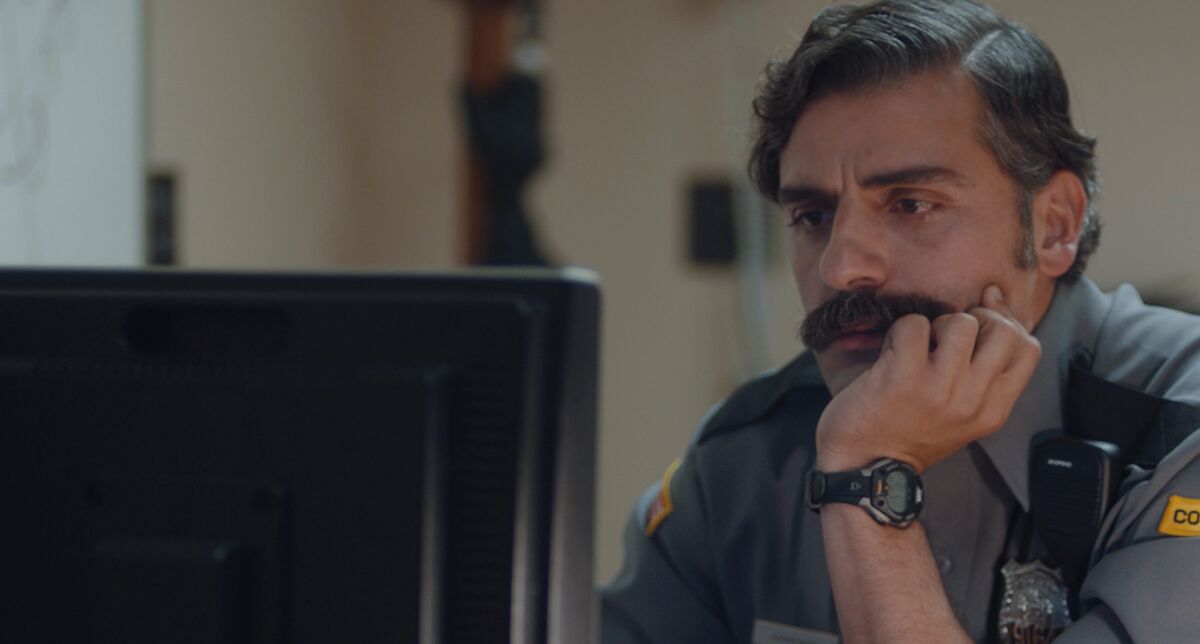 Oscar Isaac's corrections officer studies a computer screen in the live-action short "The Letter Room" by Elvira Lind.