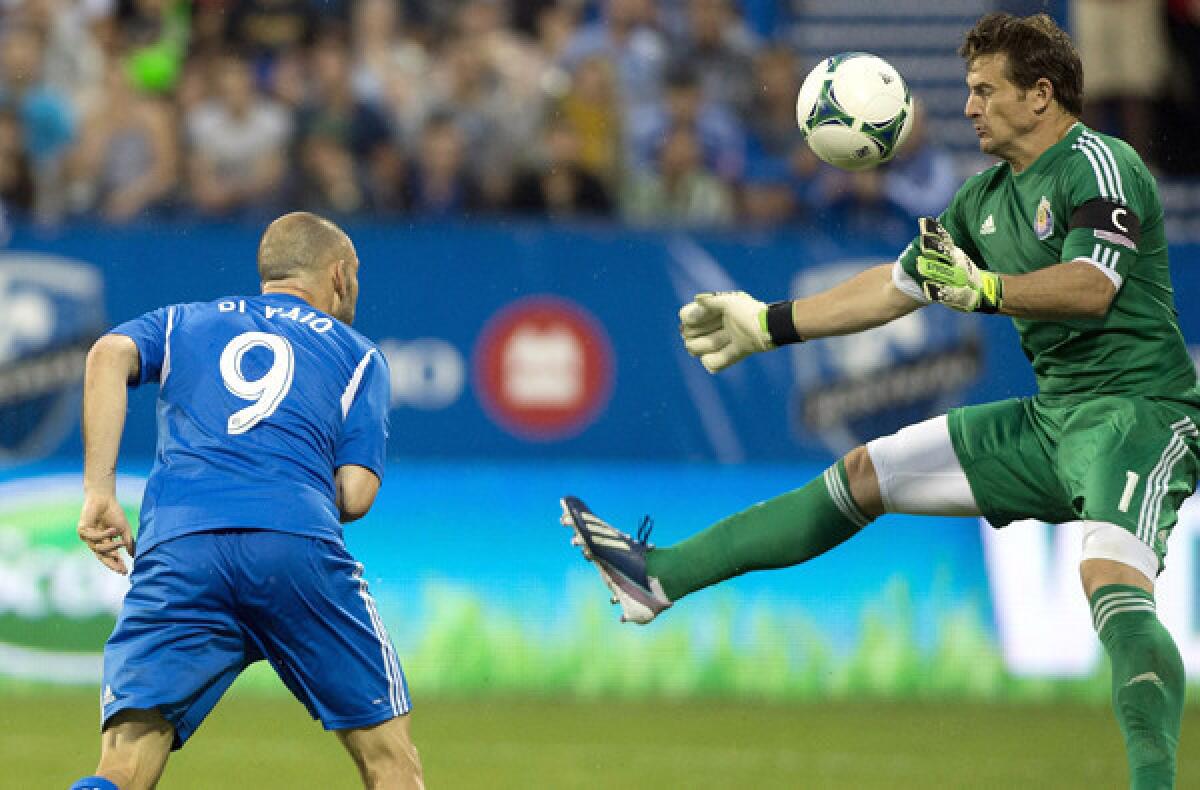 Chivas USA goalkeeper Dan Kennedy makes a save on a header by the Impact's Marco Di Vaio during a game earlier this month in Montreal.