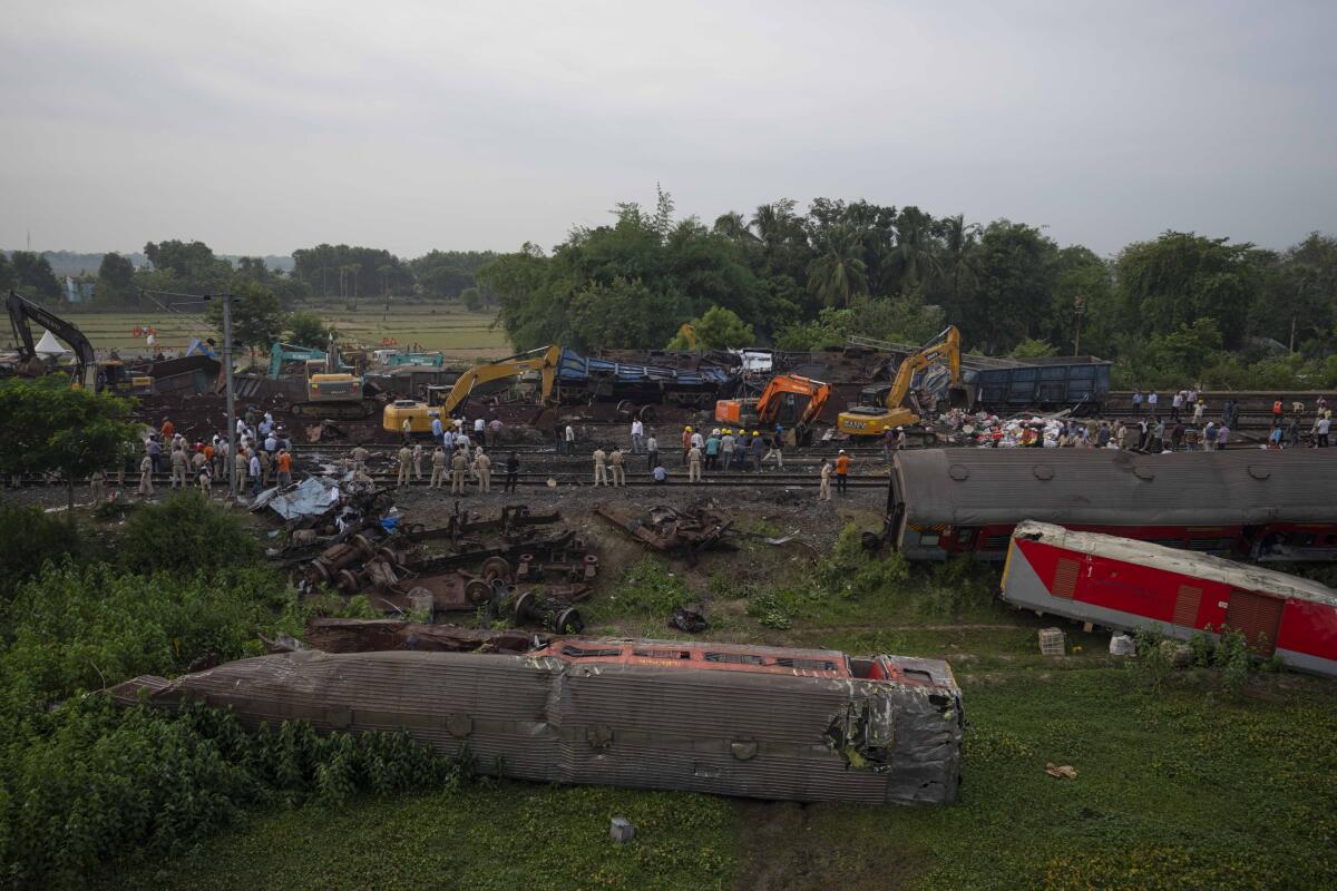 Train cars rest on their sides after a fatal crash.