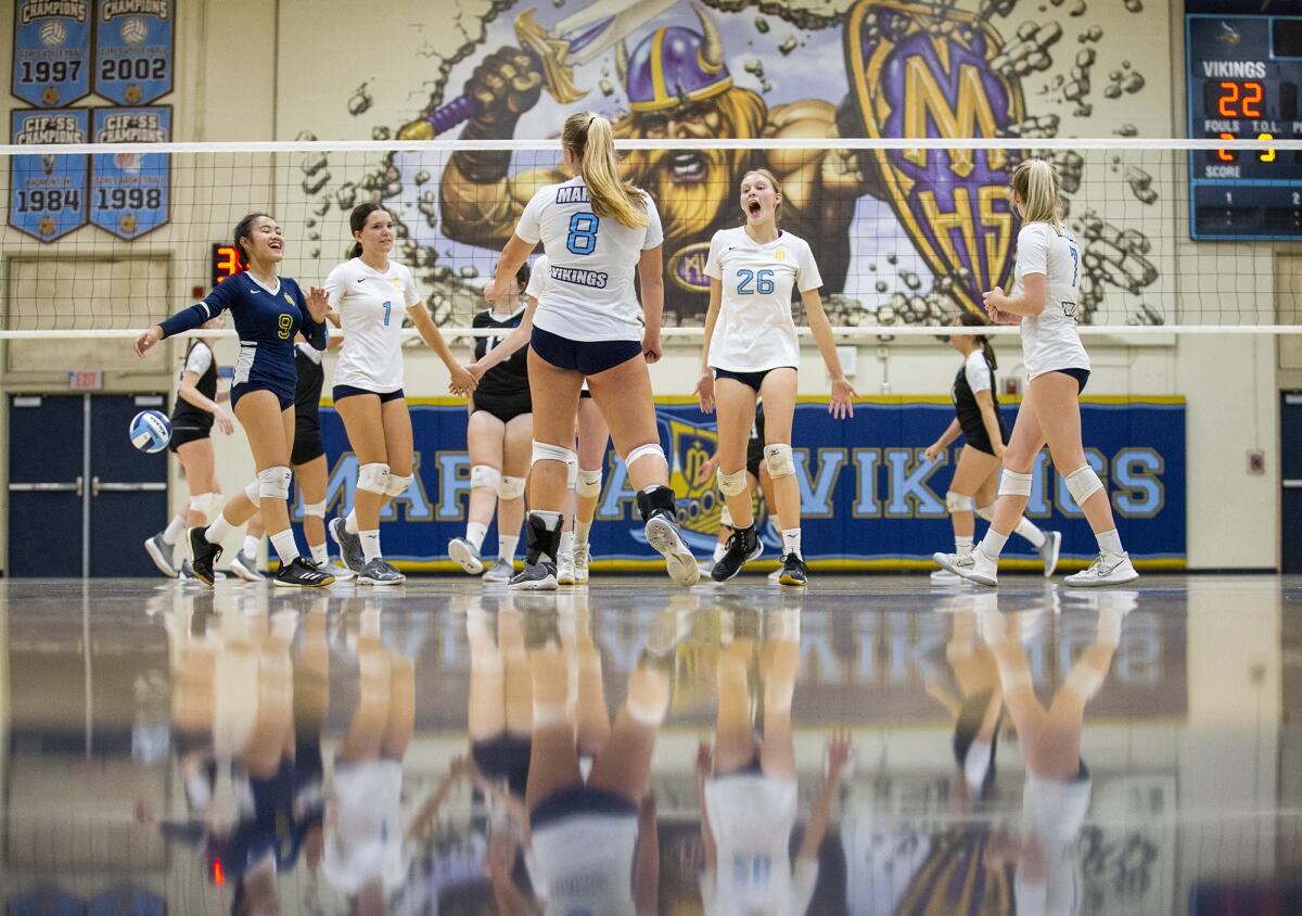 The Marina girls' volleyball team celebrates a point against Pacifica during a nonleague match on Wednesday.