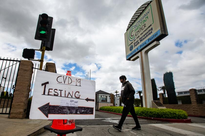 SOUTH LOS ANGELES, CA - APRIL 05: A sign directs people to drive-thru coronavirus testing at Crenshaw Christian Center on Sunday, April 5, 2020 in South Los Angeles, CA. This locations one of the first to test in South Los Angeles. People are able to drive up, revive a test, swab their own cheek and submit their sample for testing. (Jason Armond / Los Angeles Times)