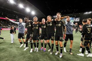 LAFC players embraced and celebrate on the pitch at BMO Stadium after finishing atop the Western Conference