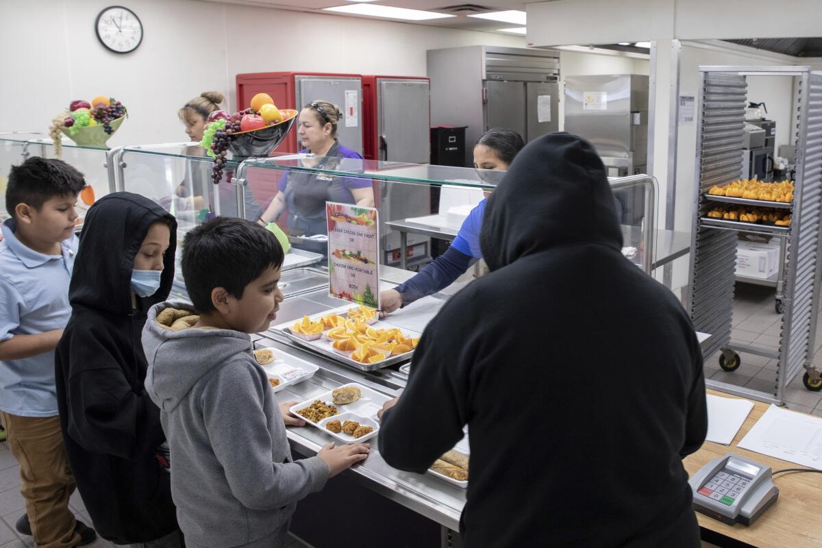 Students select their meal during lunch break in the cafeteria at V. H. Lassen Academy of Science and Nutrition in Phoenix.
